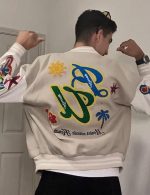 Back view of Revofits Varsity Jacket showcasing floral, star patches, and retro baseball styling.