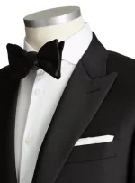 Closeup of a black tuxedo focusing on the bow tie and lapel details